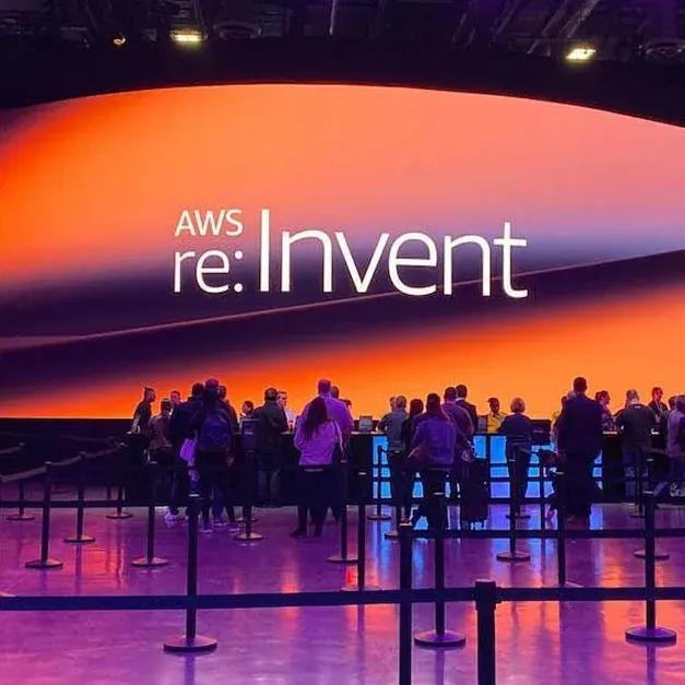 Attendees gathered in front of the AWS re:Invent main stage screen